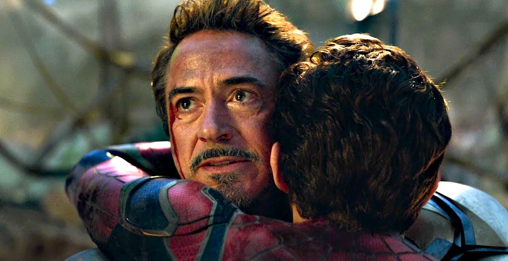 Tom Holland as Spider-Man hugging Robert Downey Jr. as Iron Man in Avengers: Endgame